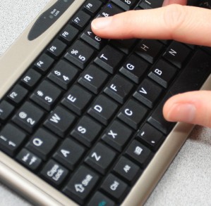 Fingers on a mini keyboard