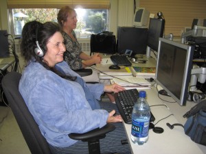 Employ-Ability participants sit at computer workstations in the Employ-Ability classroom