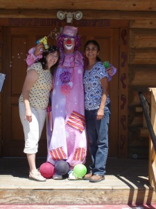 Darlene, in her clown costume, with Mindy and Terry of the Footprints to Technology program