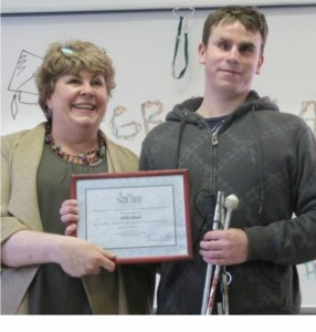 Bobby holding his certificate of completion for the Employ-Ability program with program coordinator Chris Wright