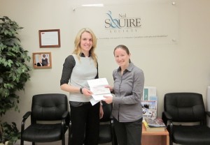 Scotiabank Customer Support Reresentative Marta Saramin presents the donation to Suzanne Cross Manager of Development and Communications for the Neil Squire Society