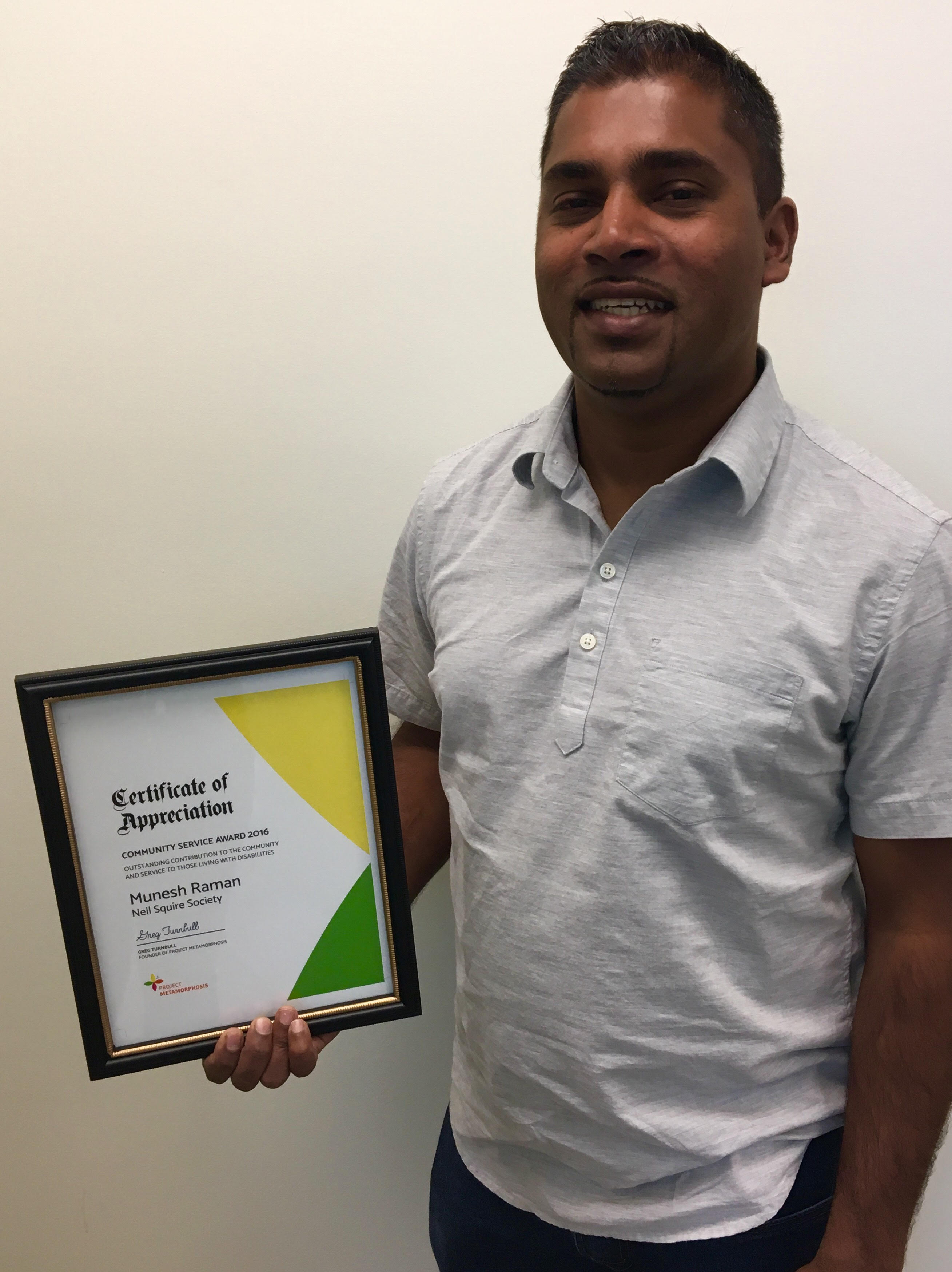 Munesh Rahman with the Community Service Award