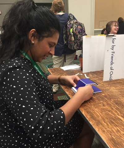 Piriya learning to build an inexpensive phone stand made of corrugated plastic