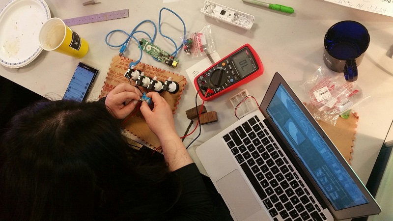 Top view of Mimi working on an accessible Wii controller