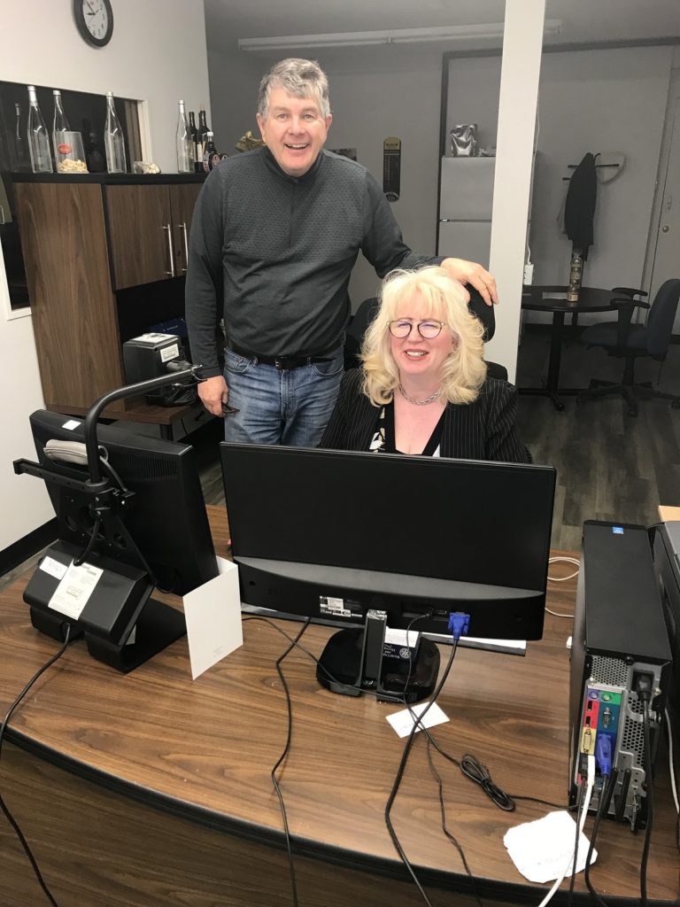 Mirjana at her desk with Roch Fortin and her assistive setup
