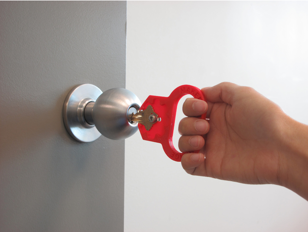A hand using a key turner to open a door