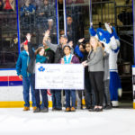 Neil Squire Society receiving their cheque on the ice