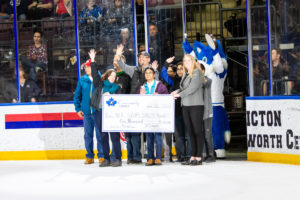 Neil Squire Society receiving their cheque on the ice