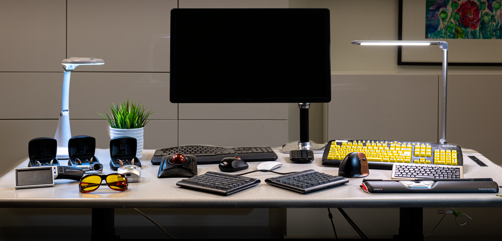 a computer desk with assistive technology on display