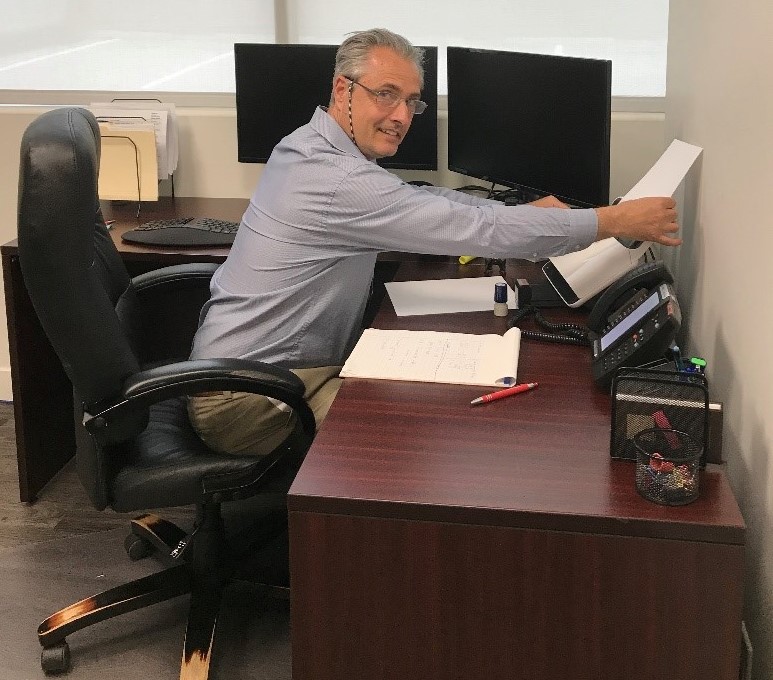 William at his desk at work