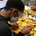 A student soldering their device together