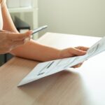 a woman uses a smartphone to scan a document