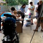 Makers work on devices in an open garage.