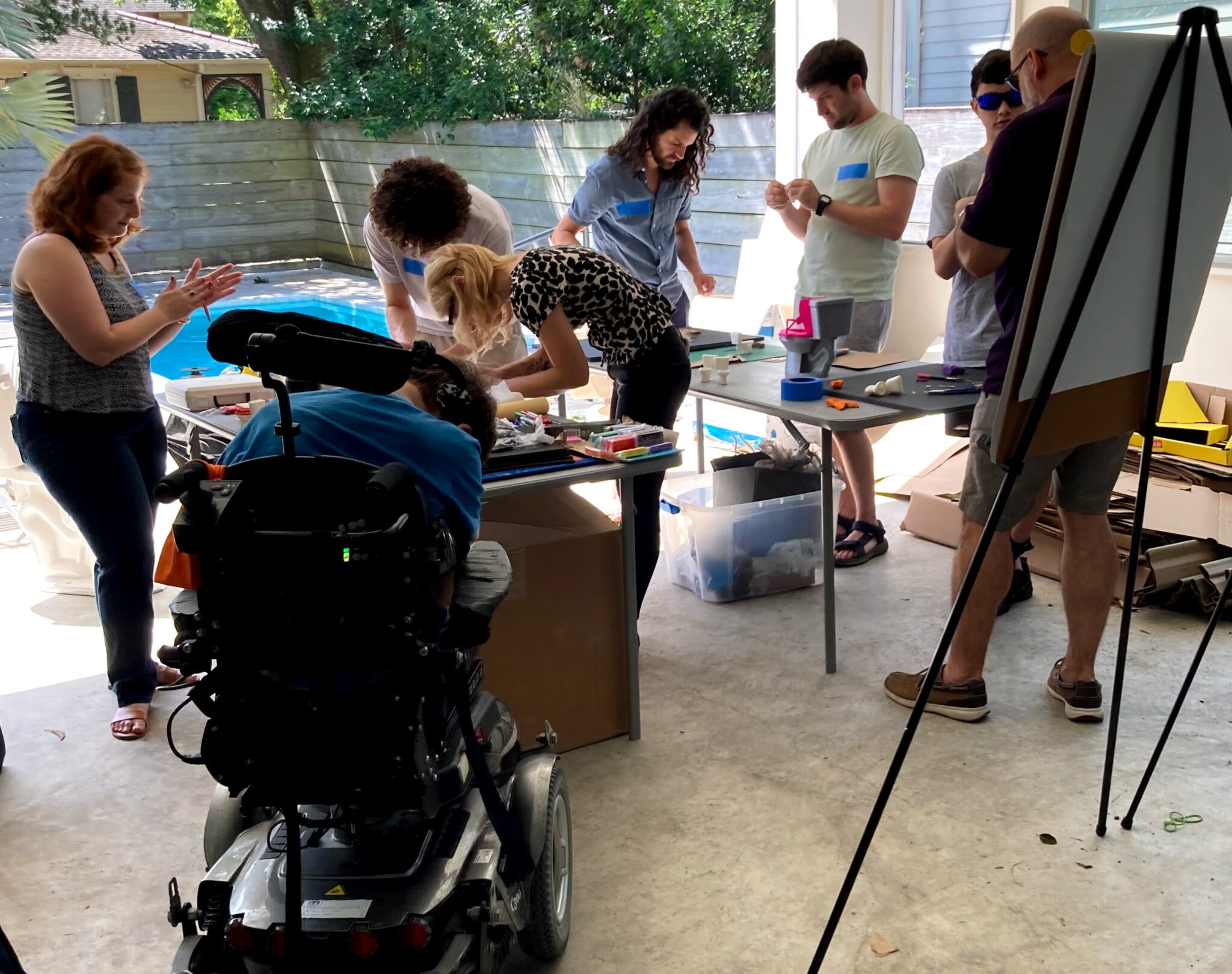 Makers work on devices in an open garage.