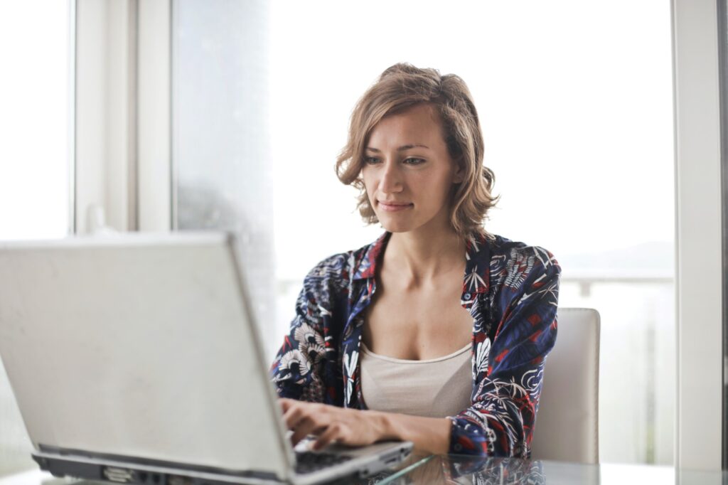 a woman typing on a laptop