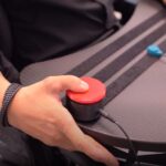 a person in a wheelchair presses on a Round Flexure Switch