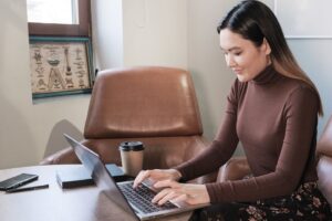 a woman working on her laptop in a home office