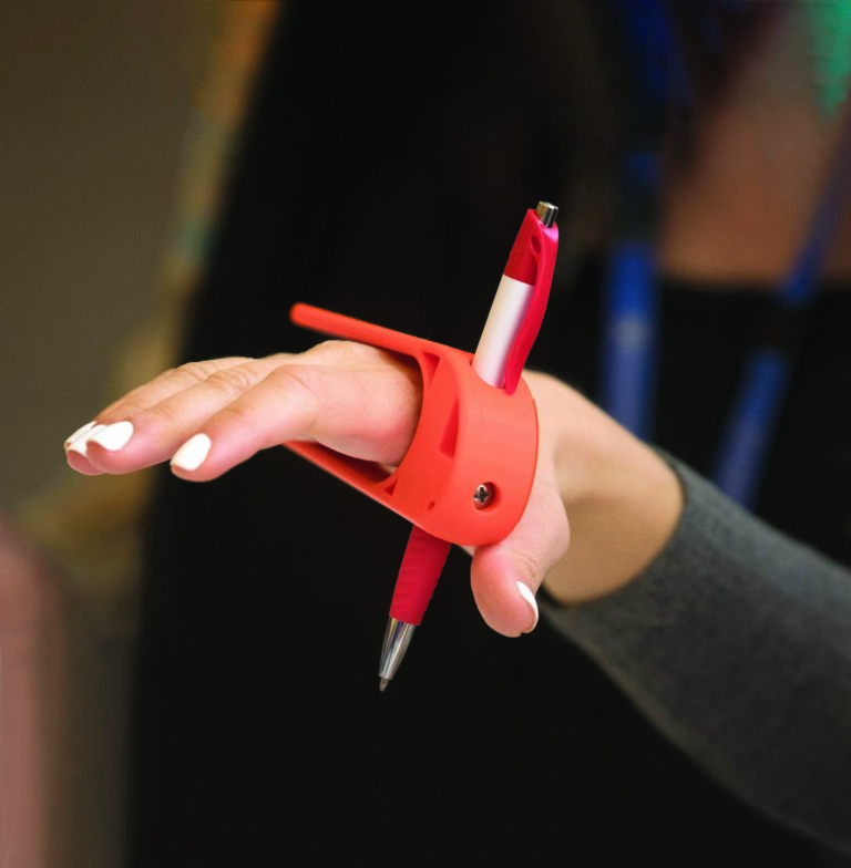 a person uses a palm pen holder