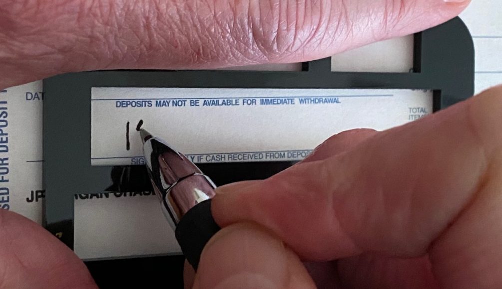 image showing someone signing using the signature guide