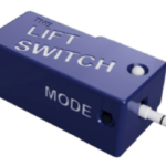 Rendered image of Lift Switch. The Lift Switch has a 3.5mm input on one side and a 3.5 mm output plug on the other end. An indicator light is on the top and a mode button is on the side.