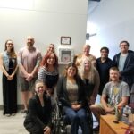 Neil Squire staff in Regina in a group photo with the AED and the plaque thanking CP