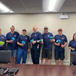 members of the Co-op Refinery Complex Emergency Response's Team (ERT) showing off the toys they have adapted