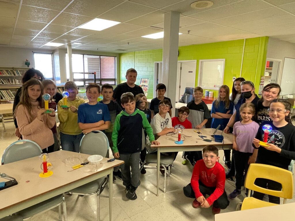 students at École Mgr-Martin show off the adapted toys they made