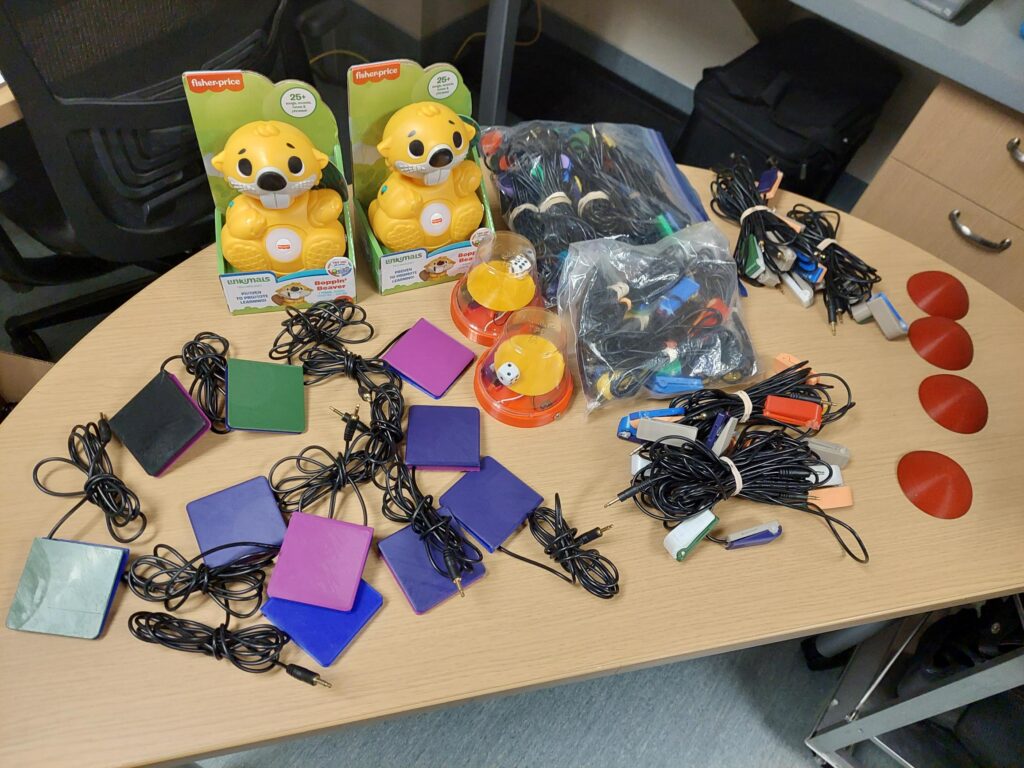 some of the devices made at the camps on a desk, including adapted toys and switches