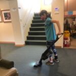 WorkBC Assistive Technology Services participant Marcie using a vaccuum