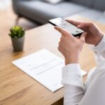 a person using an app on their phone to scan a document