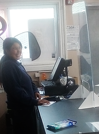 Working Together participant Lorrisa working at a cash register