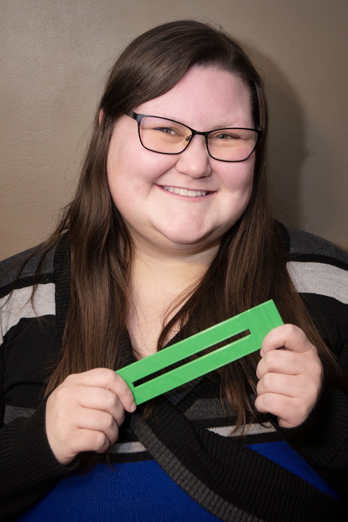MMC intern Heather holding a reading bar
