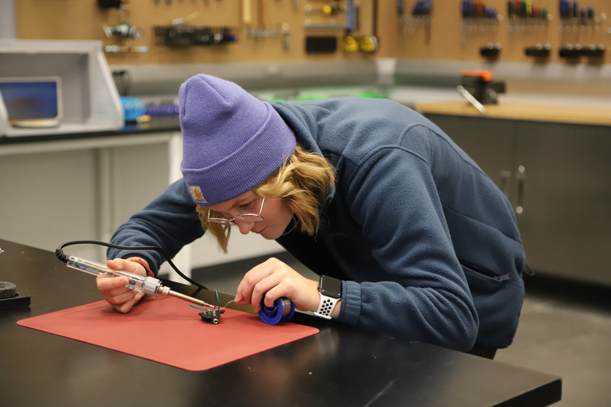 a student wearing a toque soldering
