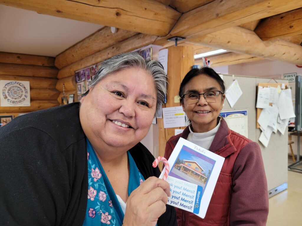 Footprints participant Patricia holding her prize, standing next to Terry, who helps run the Footprints Centre