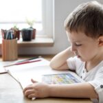 a young boy reading a book