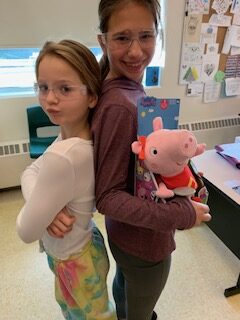 two students show off their switch adapted Peppa Pig