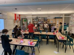 a classroom working on adapting toys guided by MMC staff