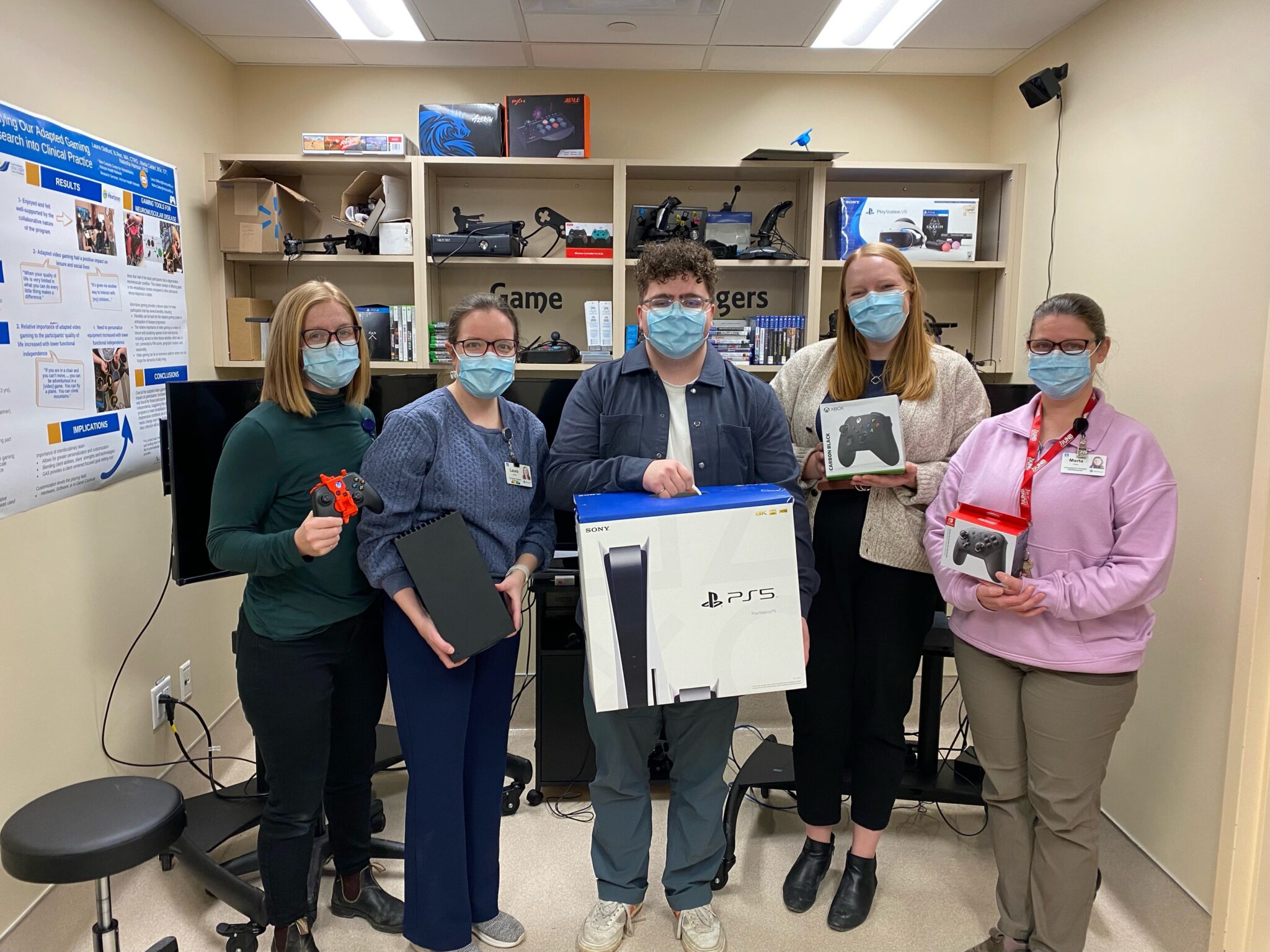 Our team and the Stan Cassidy team demonstrating the consoles and controllers donated to Stan Cassidy through the GAME Checkpoint initiative