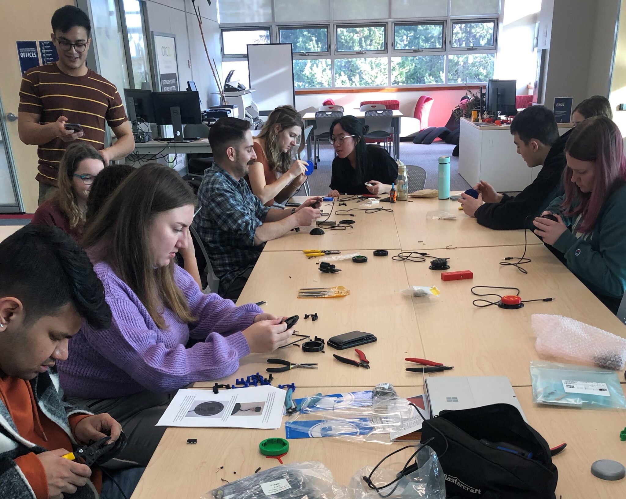 a large group of UVic BMED students building switches at their build event