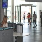 a receptionist sits at her desk in a busy building