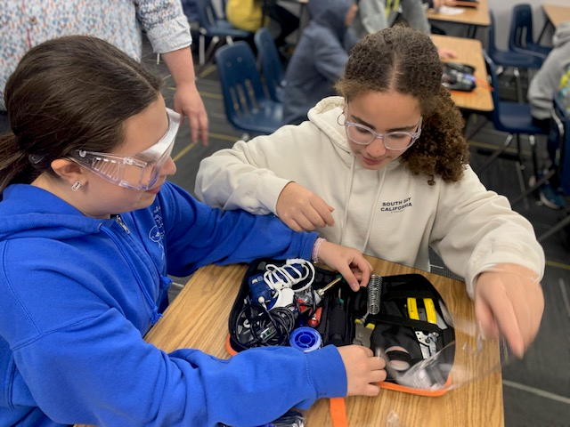 two students open up a set of tools