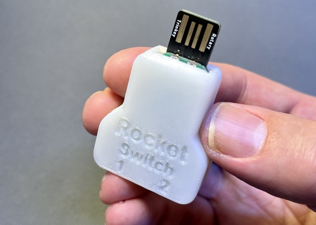 A picture of someone holding a Rocket Switch Interface.