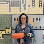 Anne-Marie holding her adapted vibrating cushion and switch.