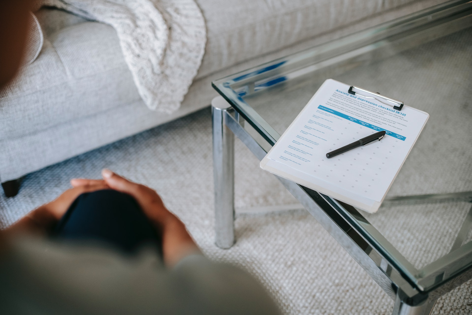 a professional looking over a checklist with depression and anxiety symptoms.
