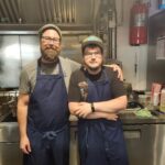 Creative Employment Options participant Stephen (right) in the kitchen with his employer.