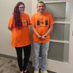 Our Calgary staff wearing orange shirts.
