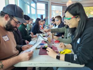 Full Circle team members get to work building joysticks.
