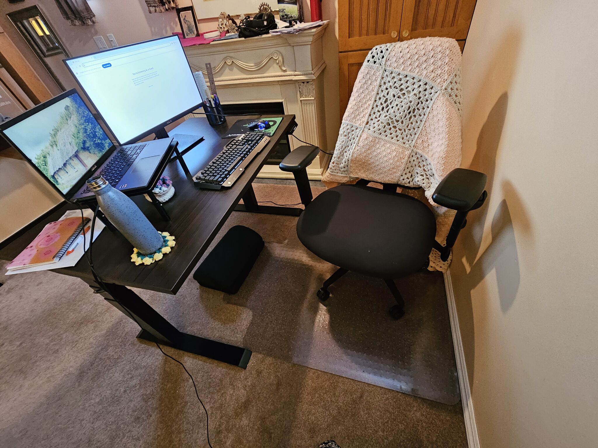 Michelle's workstation, featuring her adjustable chair, sit/stand desk, laptop riser, monitor, and other ergonomic supports.