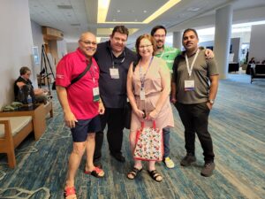 Neil Squire staff members Dale, Gordon, Bev, Joel, and Munesh pose for a photo at ATIA.