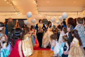 Beauty and the Beast performers enter the room.